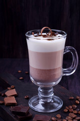 Layered dessert in an Irish glass mug with coffee and chocolate