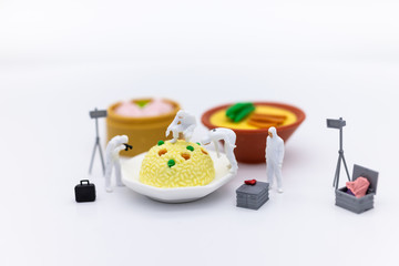 Miniature People and food, check the nutritional value, nutrients received in each meal. Image use for food and beverage concept.