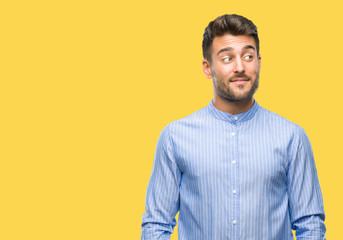 Young handsome man over isolated background smiling looking side and staring away thinking.