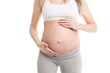 Close-up of pregnant woman touching her belly