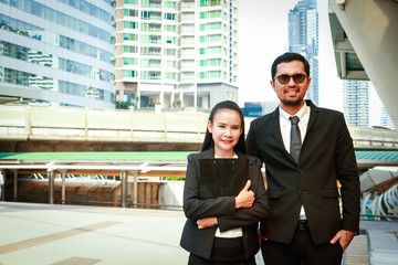 Young working people wearing suits Standing in the middle of the business district