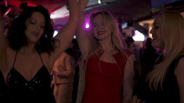 a group of friends dancing and having fun at a concert