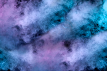 A blast of smoke evaporating in the colors of the rainbow: red, orange, yellow, green, cyan, magenta against a dark background.