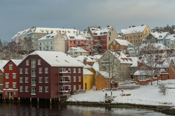 Fototapeta na wymiar Baklandet street under snow. Wintertime in Trondheim, Norway.