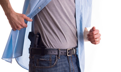 Man drawing concealed carry pistol
