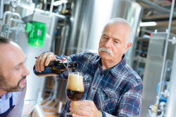 male quality control workers in beer factory