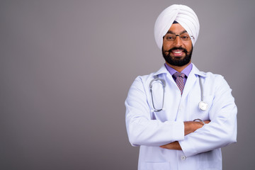 Portrait of young Indian Sikh man doctor smiling