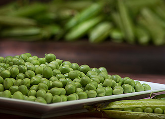 Fresh pea grains (Pisum sativum) shelled in the foreground