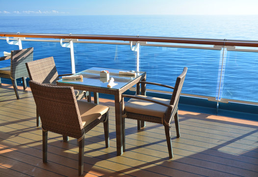 Restaurant tables on the open deck of cruise ship.