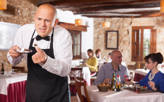 Waiter expressing  displeasure with small tips