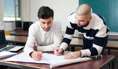 Students working with laptop at desk
