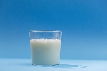glass of milk on blue background
