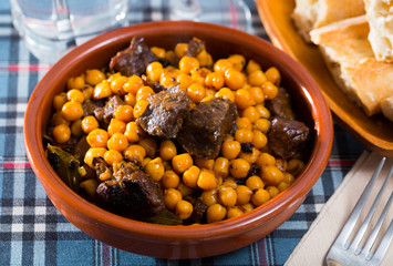 Beef stew with chickpeas in a clay plate