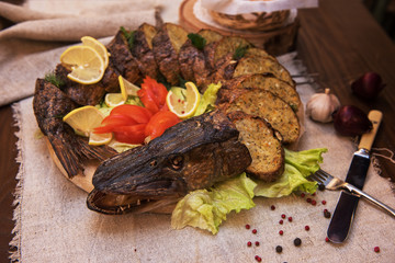 Stuffed pike with vegetables and greens. Russian food