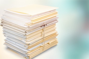 Stack of documents in folders isolated on white