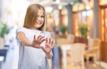 Young beautiful girl over isolated background disgusted expression, displeased and fearful doing...