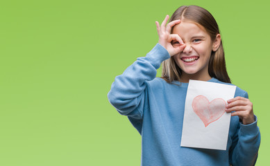 Young beautiful girl giving mother father day card with red heart over isolated background with...