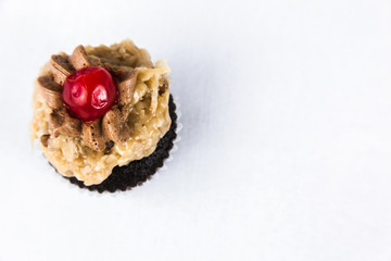 Obraz na płótnie Canvas German Chocolate Cupcake With Cherry On Top