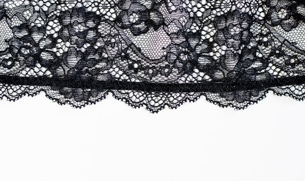 Black lace texture with flowers on a white background.Background of black lace with a flower pattern on a white background. Black guipure. Black fabric with an ornament. 