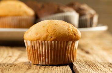 Vanilla cupcake, homemade cakes on wooden background