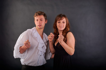 a couple in love stands on a dark background