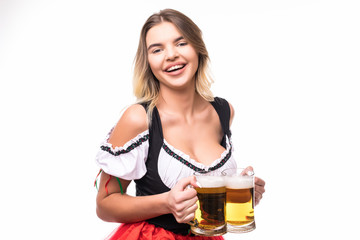 Young and beautiful bavarian girl wear in dirndl with two mugs of beer isolated over white background