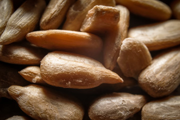 Peeled, roasted and salted sunflower seeds. Macro close-up photography.