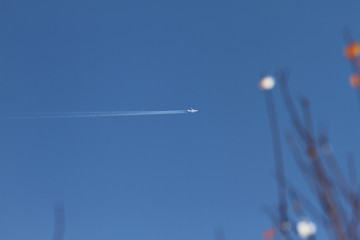 Airplane on a blue sky. Dream vacation concept. travel and tourism. Blue background texture. Wallpaper of airplane in the sky.
