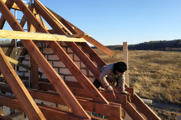 Layout and installation of roof rafters on a new commercial residential construction project by framing contractors