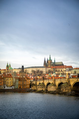 Obraz premium Panorama of Charles bridge and Prague castle over Vltava river in cloudy day, Czech Republic