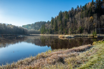 Obraz premium blue sky and clouds reflecting in calm water of river Gauja in latvia in autumn