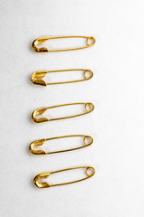 golden pins on white background