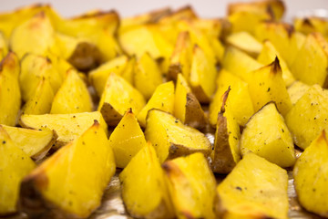 Baked potato wedges with herbs are ready to eat. Homemade potato wedges snack food.
