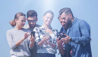 group of young people using smartphones.
