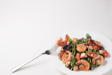 Fresh salad plate with shrimp, tomato and mixed greens. Healthy food. Clean eating.
