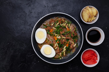 Home food Asia, Vietnam, egg noodle soup, colorful food ingredient for this food such as egg, beef, broth, ginger, soy sauce, carrot, vegetable