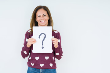 Middle age woman thinking and holding paper with question mark symbol over isolated background with a happy face standing and smiling with a confident smile showing teeth