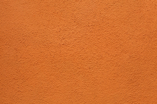Orange painted stucco wall. Background texture.