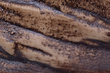 Dark abstract background texture. Close-up of a detail from a brown clay mug. Macro.
