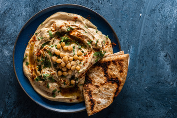 Classic Hummus with chickpeas, paprika, olive oil and oriental spices. Mediterranean popular snack...
