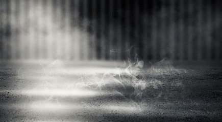 Black background of empty street, premises, blue searchlight illuminates asphalt, laser beams, smoke