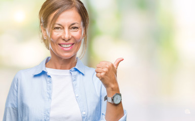 Middle age senior hispanic woman over isolated background doing happy thumbs up gesture with hand. Approving expression looking at the camera with showing success.