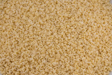 Alphabet pasta on black background