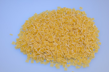 Uncooked small pasta on white background