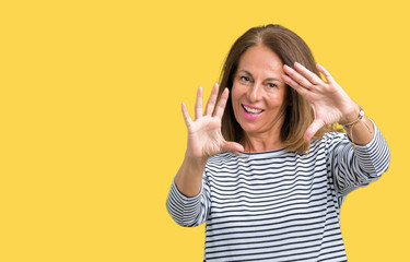 Beautiful middle age woman wearing stripes sweater over isolated background Smiling doing frame using hands palms and fingers, camera perspective