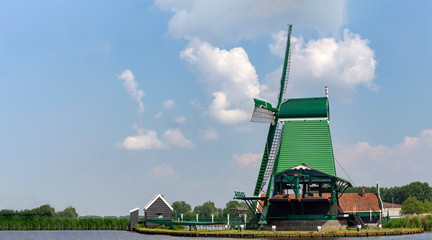 Dutch sawmill at the border of the lake waiting for tree trunks delivery, Zaanse Schans, Netherlands