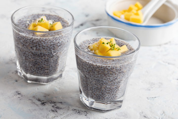 Mango chia pudding with almond milk in glasses, healthy  breakfast meal