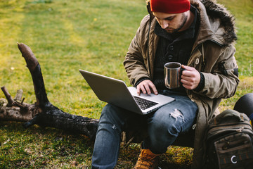 Young blogger photographer travel in mountain forest