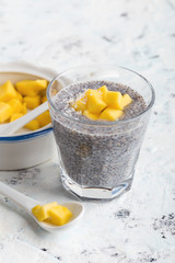 Mango chia pudding with almond milk in glasses, healthy  breakfast meal