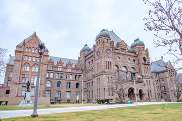 Fototapeta premium Scenic view of Legislative Assembly of Ontario in Toronto. Beautiful winter look of ancient historic building in center of largest megapolis of Ontario province and Canada